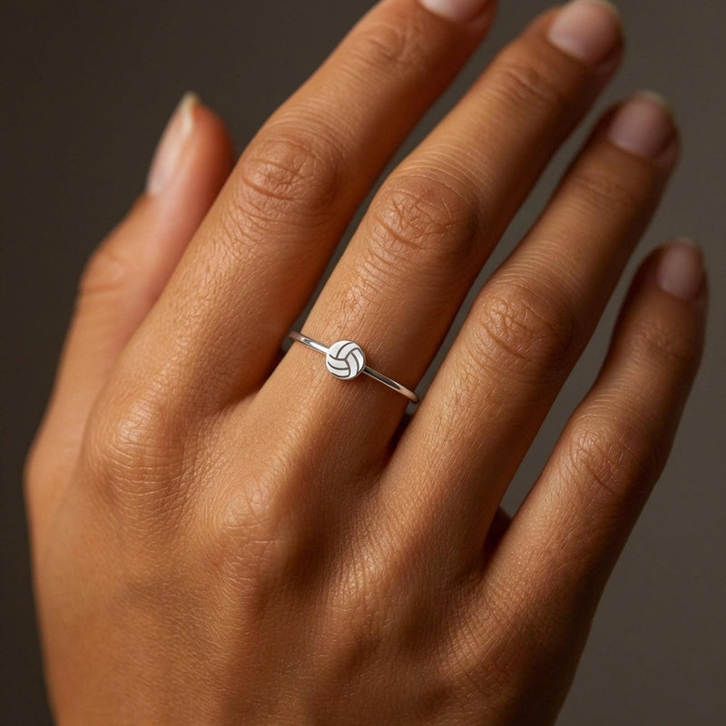 Thin gold stacking ring with a tiny volleyball charm sitting flat on the band (5 of 7)