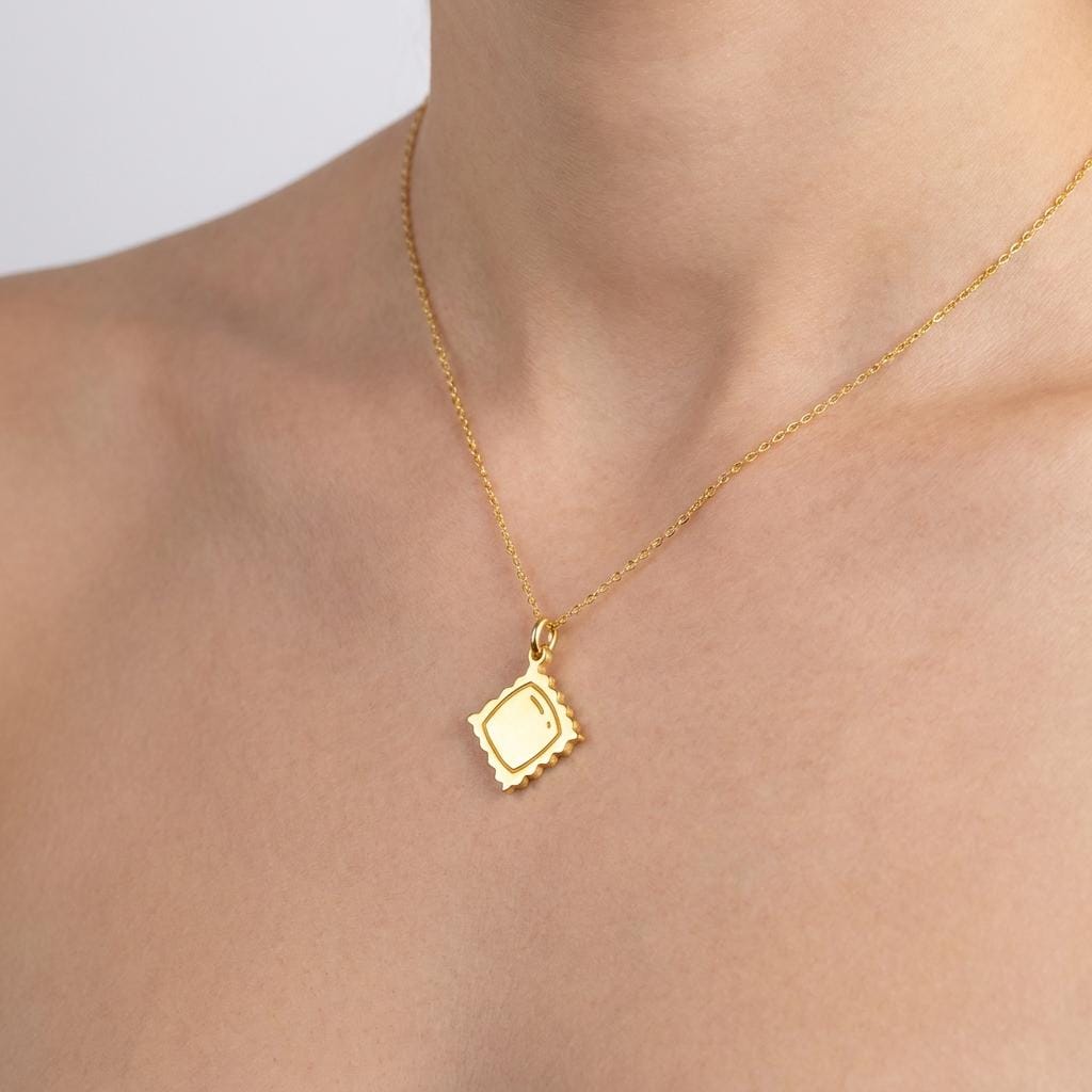 Small gold ravioli pendant with crimped edges and a pillowed center on a chain (2 of 8)