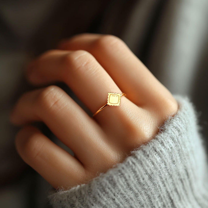 Tiny gold ravioli pasta charm sitting flat on a slim round ring band (8 of 8)