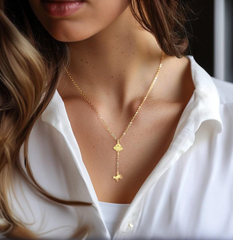 Gold UFO pendant beaming up a tiny cow, hung on a fine cable chain (7 of 10)