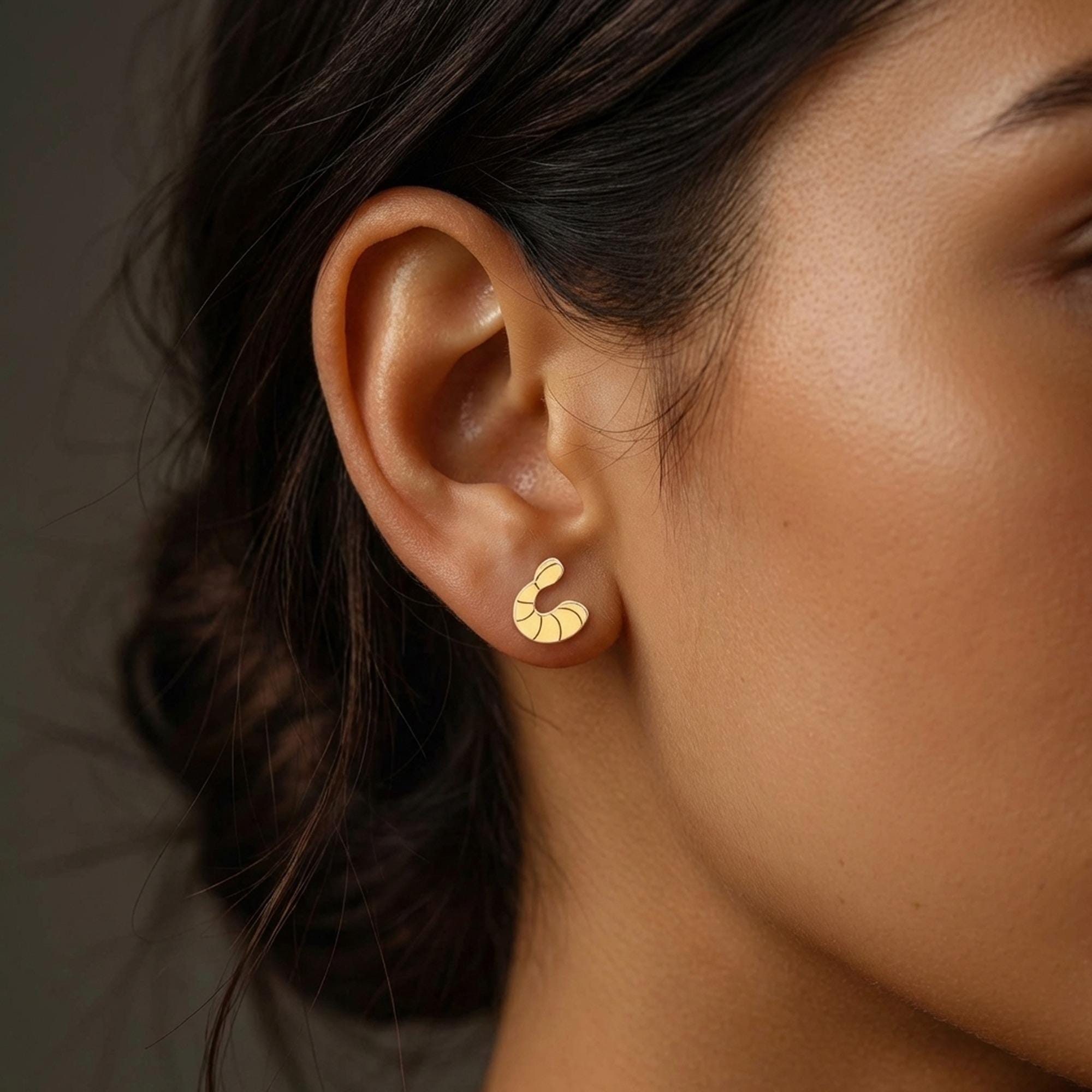 Pair of small gold shrimp stud earrings with curled tails and segmented shells (2 of 9)