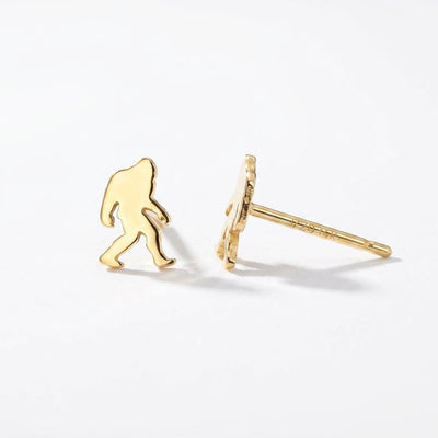 Pair of small gold Bigfoot stud earrings shown mid-stride with posts and backs