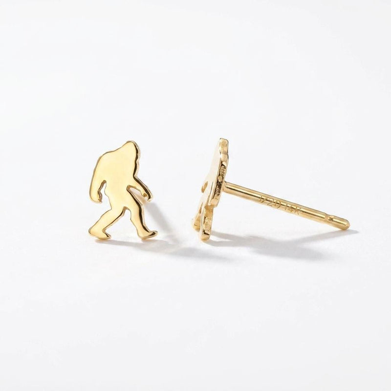 Pair of small gold Bigfoot stud earrings shown mid-stride with posts and backs