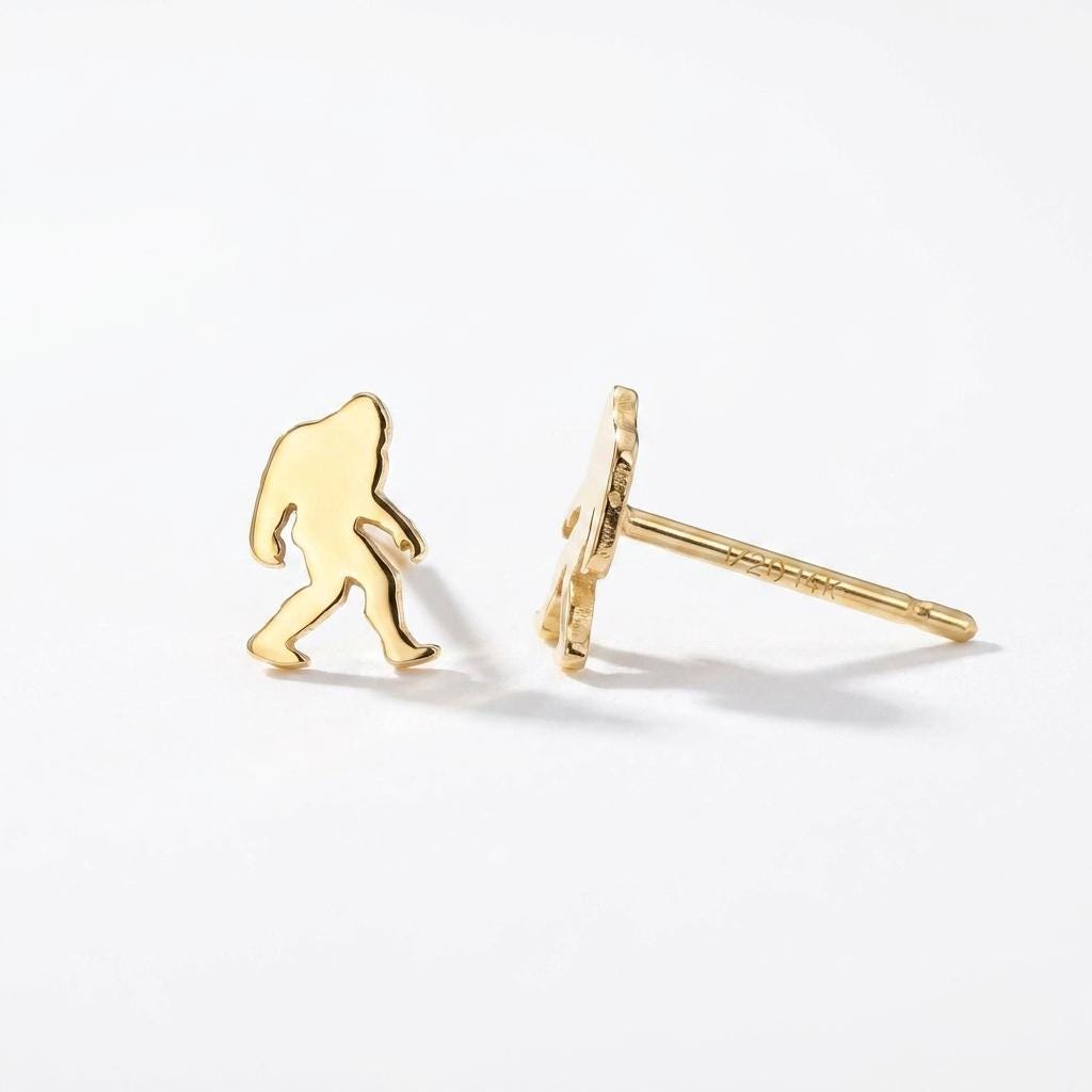 Pair of small gold Bigfoot stud earrings shown mid-stride with posts and backs