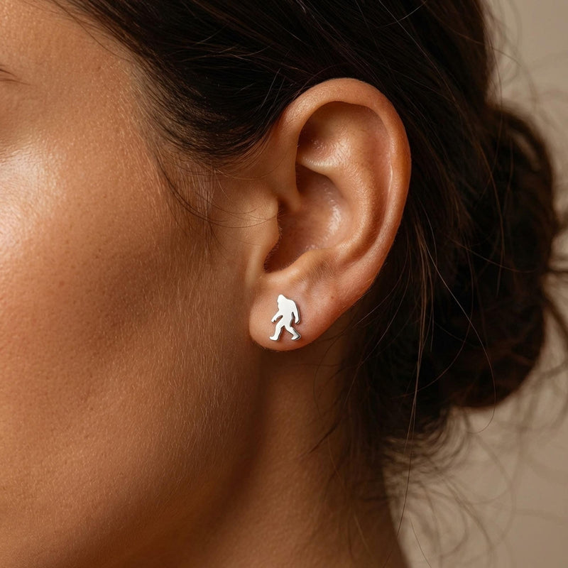 Pair of small gold Bigfoot stud earrings shown mid-stride with posts and backs (4 of 9)