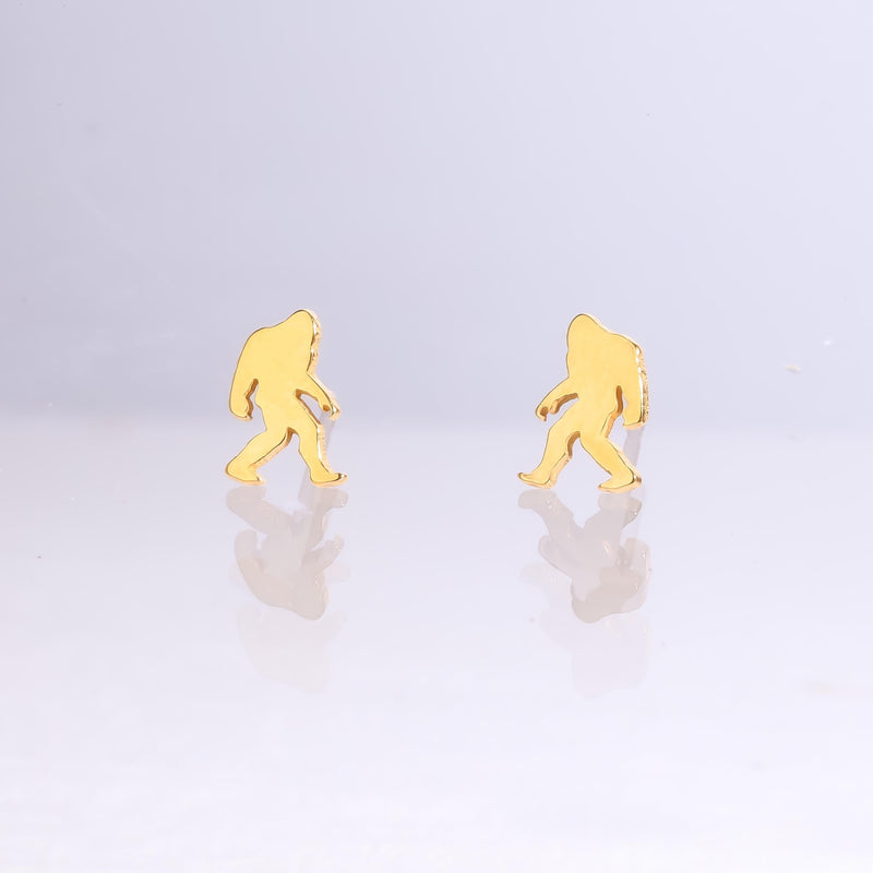 Pair of small gold Bigfoot stud earrings shown mid-stride with posts and backs (8 of 9)