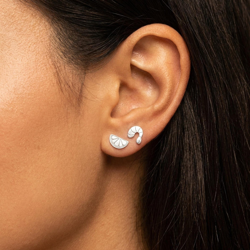 Mismatched gold stud earrings, a curled shrimp and a lemon wedge, on white (3 of 8)