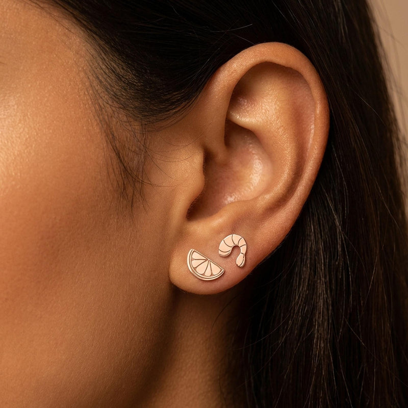 Mismatched gold stud earrings, a curled shrimp and a lemon wedge, on white (4 of 8)
