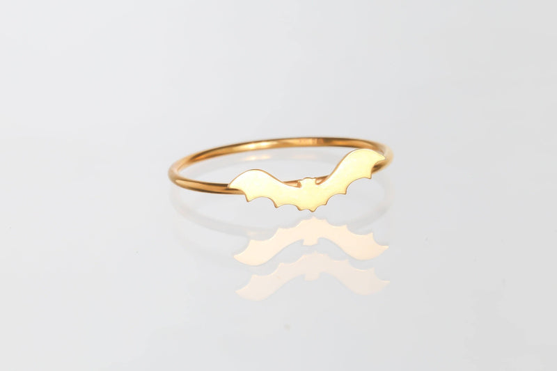 Slim gold ring with a tiny flat bat charm sitting on the band (7 of 15)