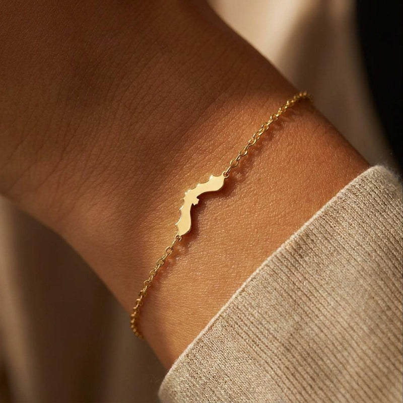 Thin gold chain bracelet with a small bat charm with spread wings (2 of 10)