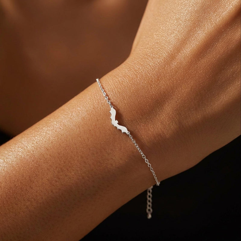 Thin gold chain bracelet with a small bat charm with spread wings (3 of 10)