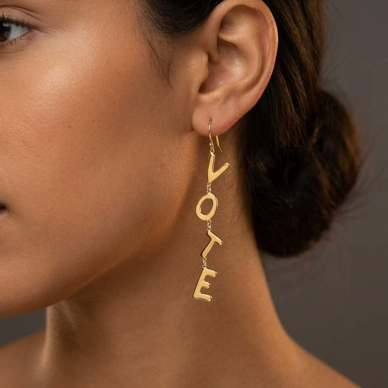 Pair of long gold earrings spelling the word VOTE in cut out letters (4 of 8)