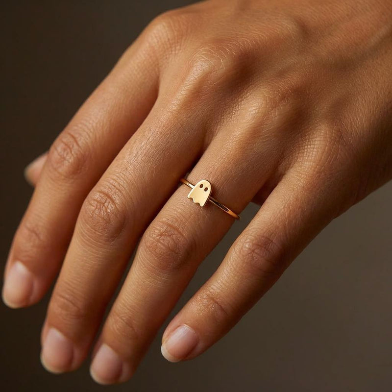 Thin gold stacking ring with a small flat ghost shape on the band (2 of 15)
