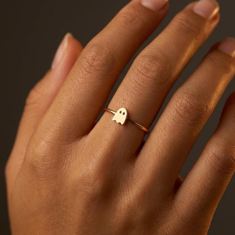Thin gold stacking ring with a small flat ghost shape on the band (5 of 15)