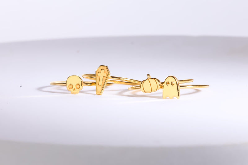 Dainty gold skull ring, small flat skull on a thin round band, worn on a hand (11 of 14)