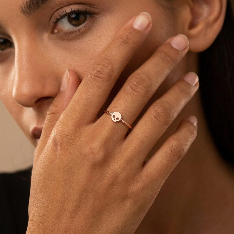 Dainty gold skull ring, small flat skull on a thin round band, worn on a hand (4 of 14)