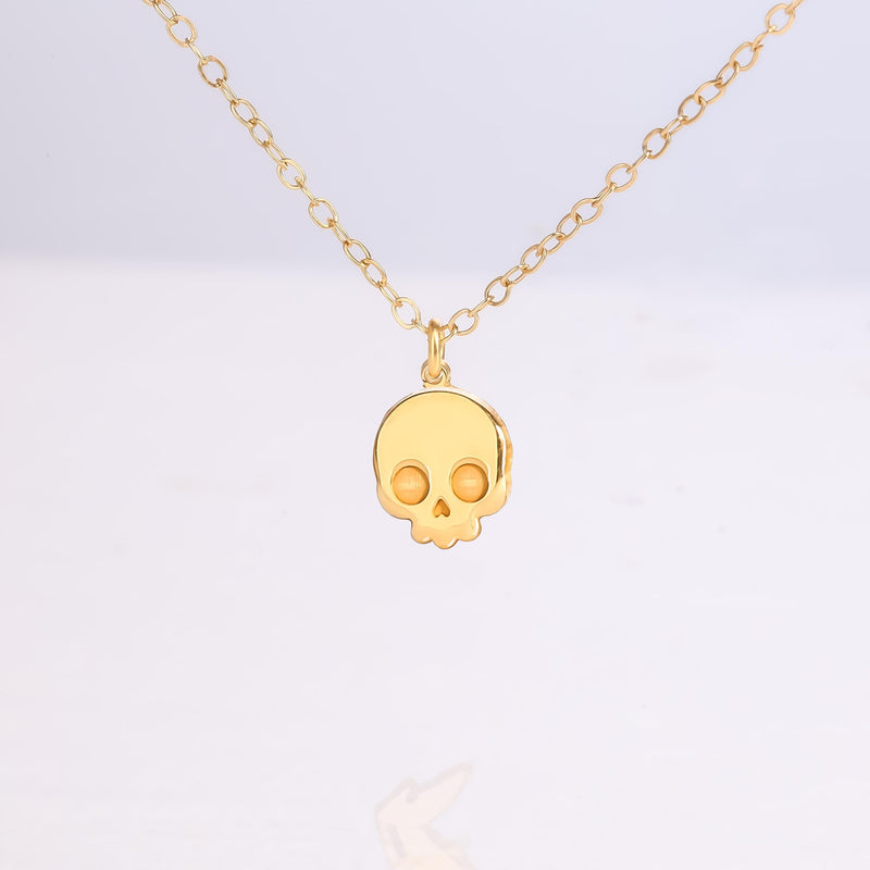 Small gold skull pendant with defined eye sockets on a fine cable chain (2 of 7)