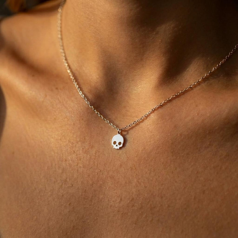 Small gold skull pendant with defined eye sockets on a fine cable chain (4 of 7)