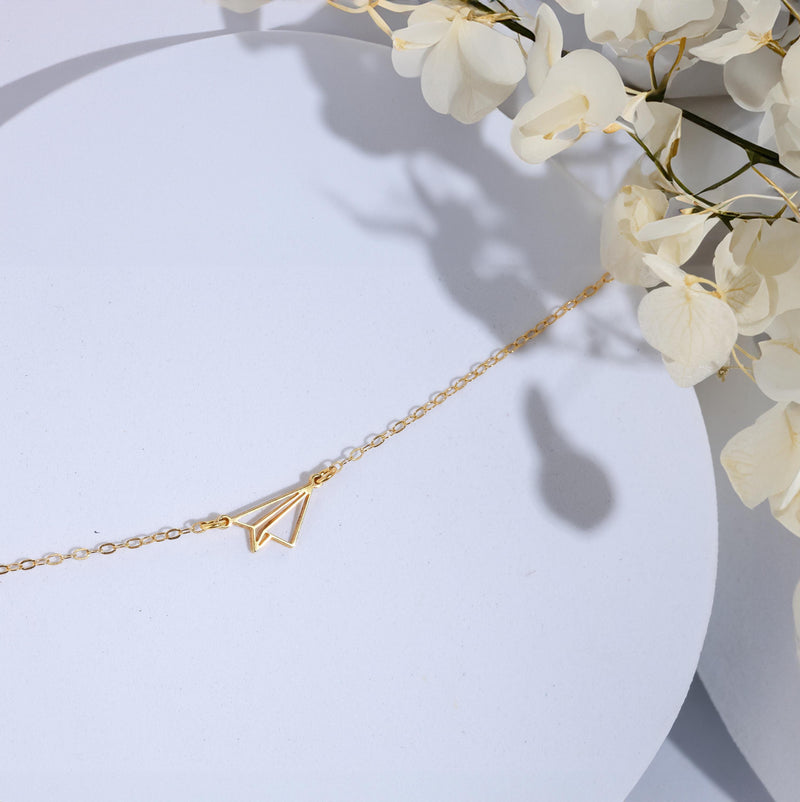 Gold folded paper airplane charm necklace on a fine cable chain (7 of 11)