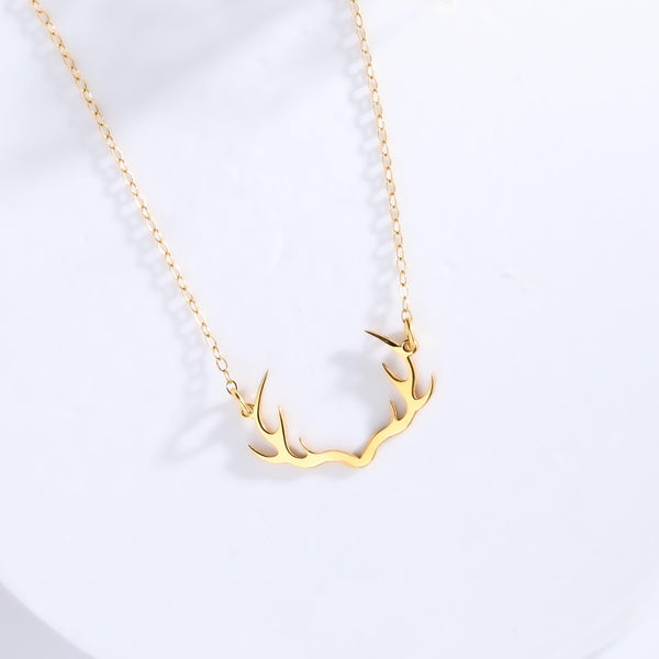 Gold deer antler pendant with visible tines on a thin cable chain