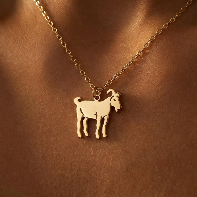 Small flat gold goat pendant in profile on a fine chain