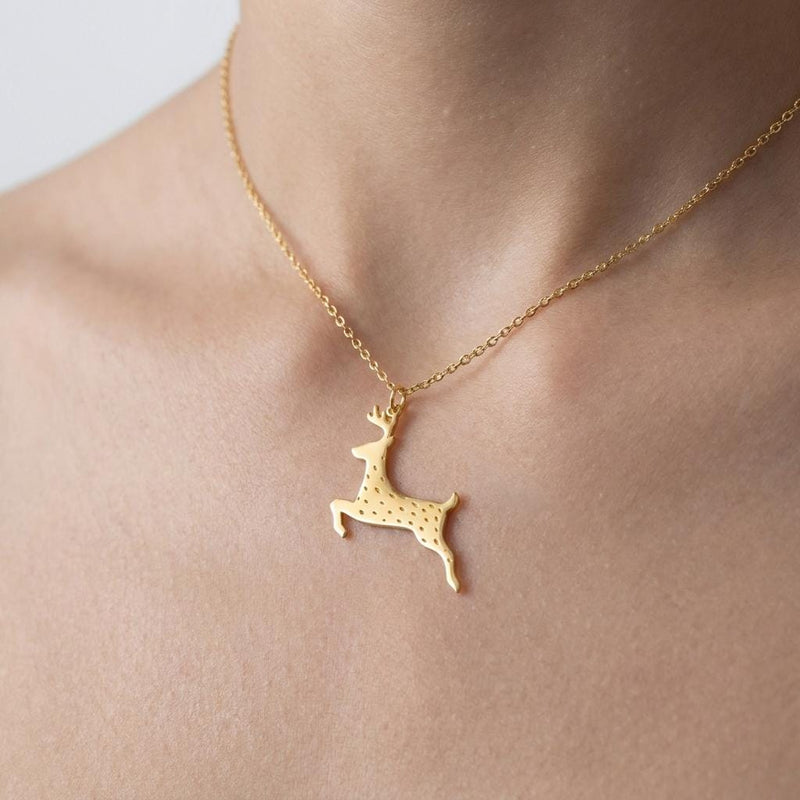 Flat gold reindeer head pendant with antlers on a fine cable chain.