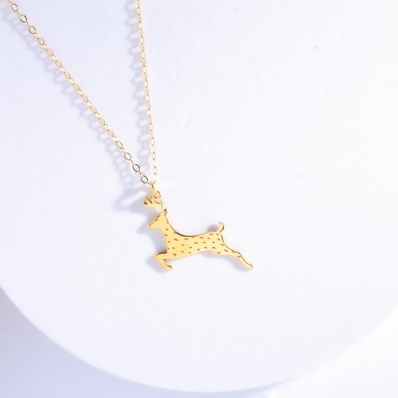 Flat gold reindeer head pendant with antlers on a fine cable chain. (3 of 9)