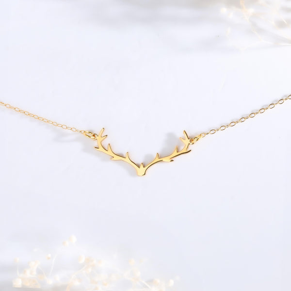 Gold branched reindeer antler pendant hanging from a thin cable chain