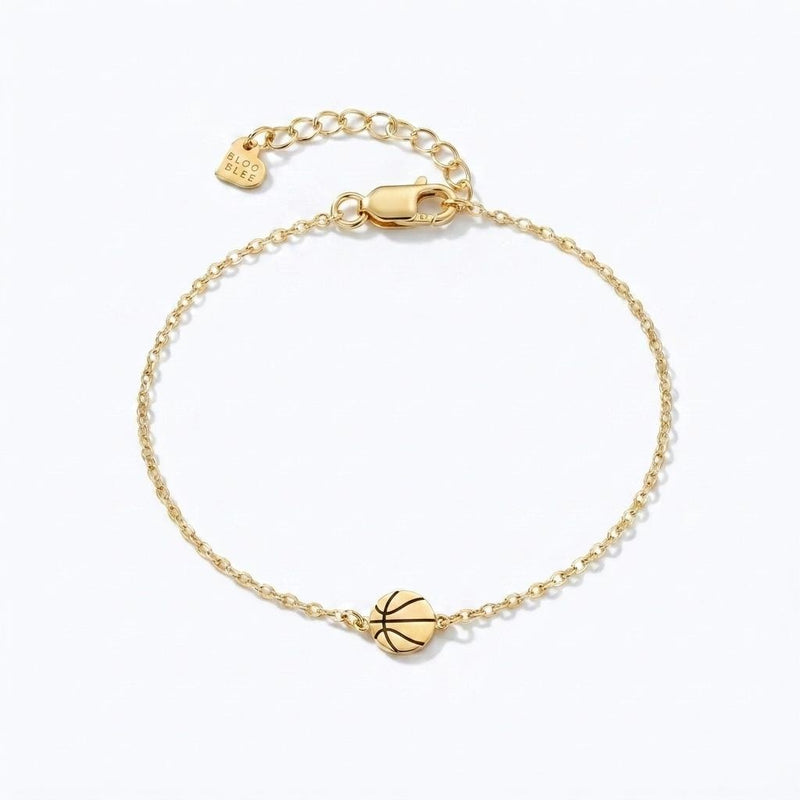 Fine gold chain bracelet with a tiny basketball charm and lobster clasp