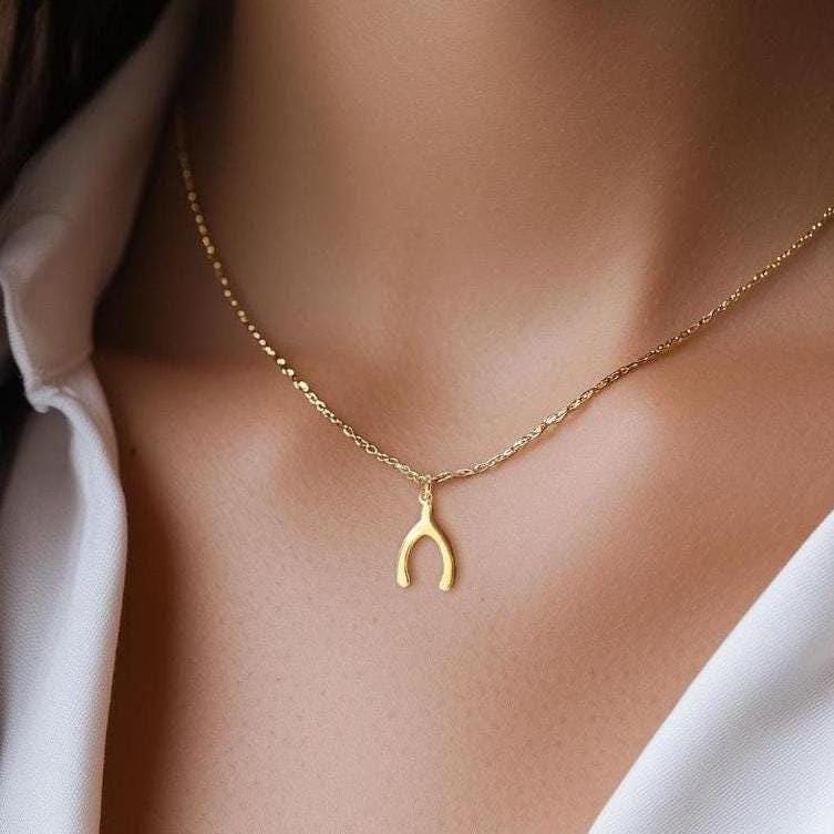 Small gold wishbone pendant hanging from a fine cable chain (2 of 12)