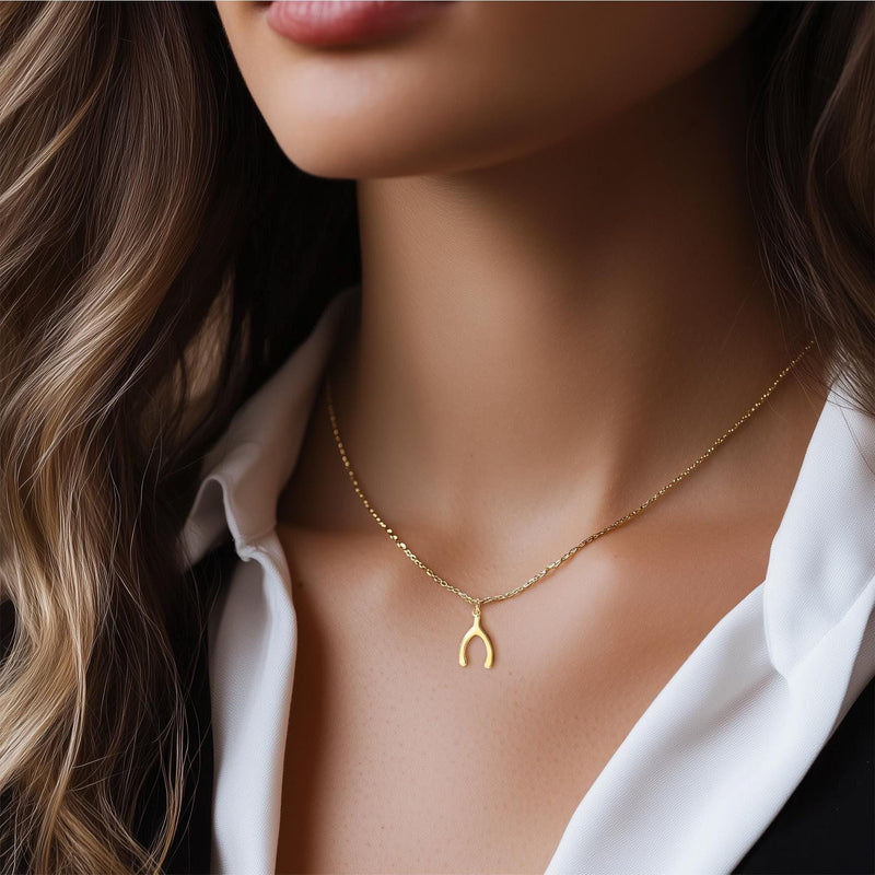 Small gold wishbone pendant hanging from a fine cable chain (4 of 12)