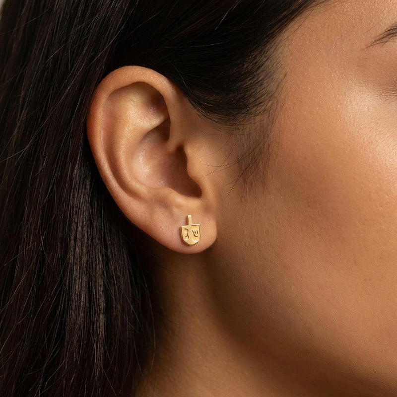 Pair of small gold dreidel stud earrings with a short handle and flat faces. (4 of 8)