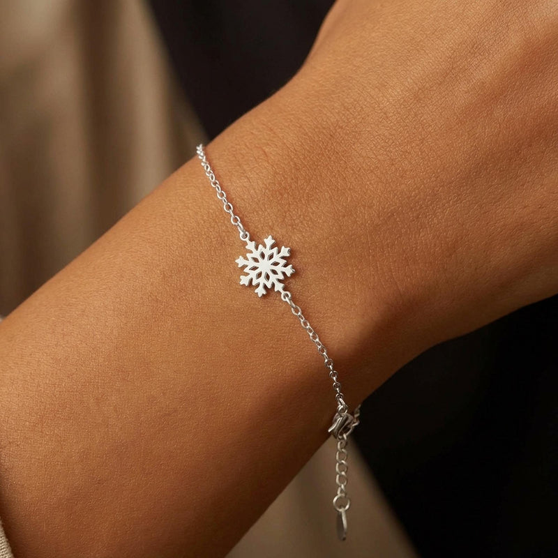 Fine gold bracelet with a small six armed snowflake charm (4 of 9)