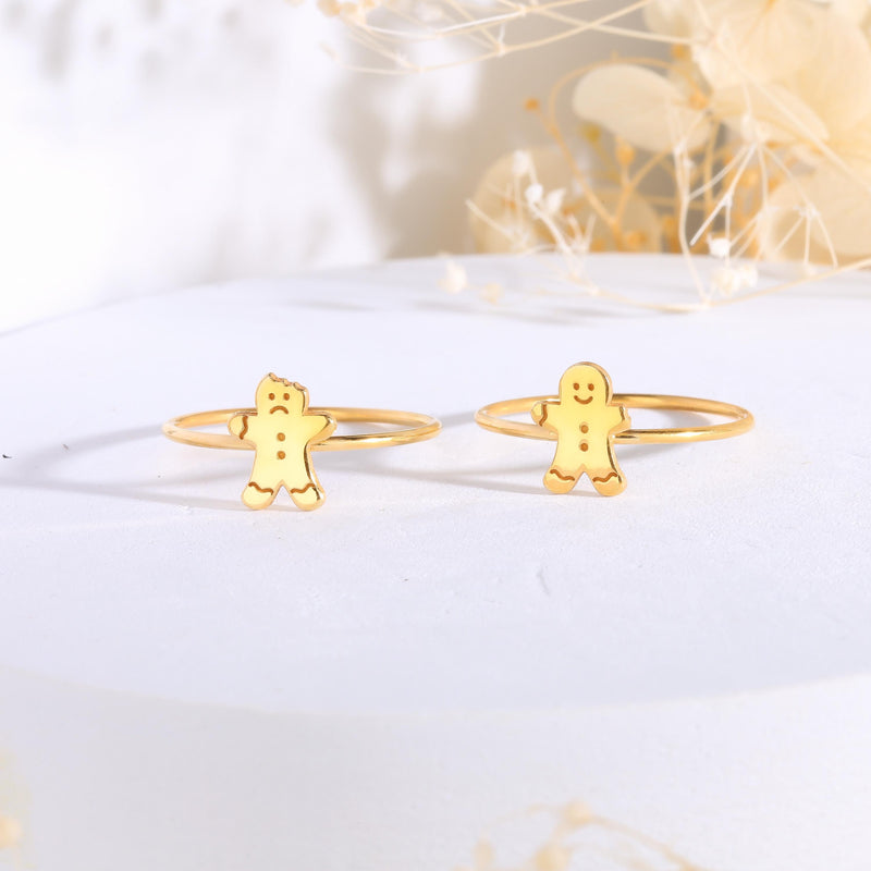 Gold ring with a small smiling gingerbread man charm on a thin band (2 of 8)