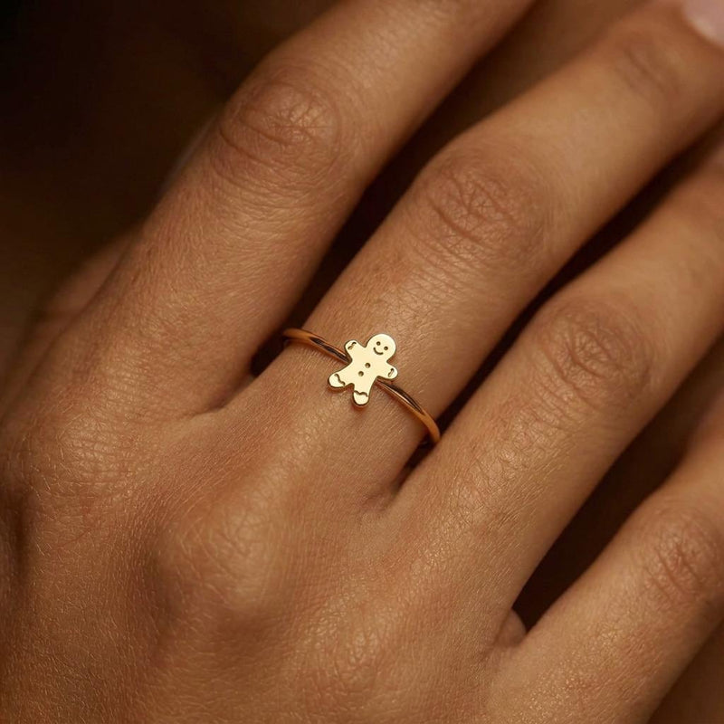 Gold ring with a small smiling gingerbread man charm on a thin band (3 of 8)