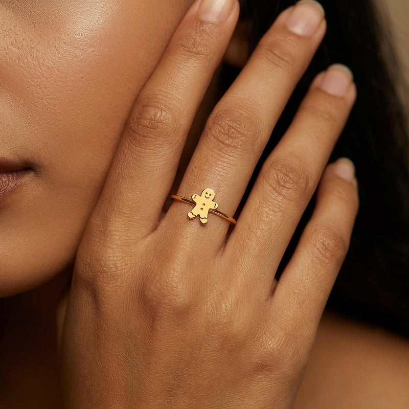 Gold ring with a small smiling gingerbread man charm on a thin band (4 of 8)