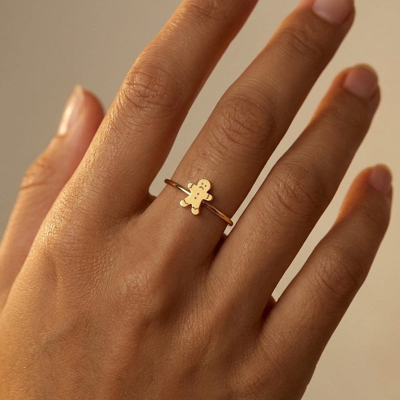 Gold ring with a small smiling gingerbread man charm on a thin band (5 of 8)
