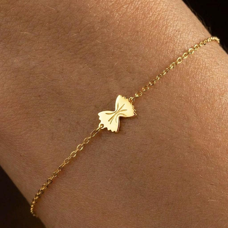 Tiny gold bowtie pasta charm on a fine cable chain bracelet (2 of 7)