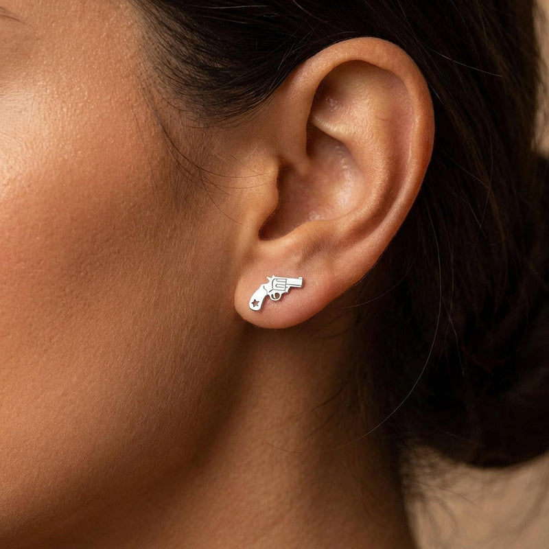 Pair of tiny gold revolver stud earrings with the barrel pointing forward (4 of 8)