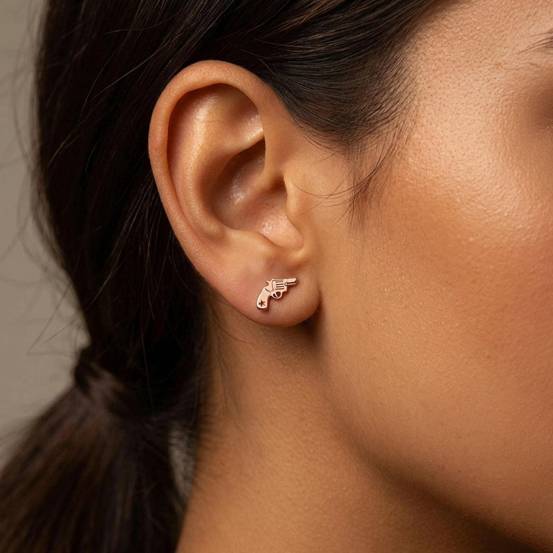 Pair of tiny gold revolver stud earrings with the barrel pointing forward (5 of 8)
