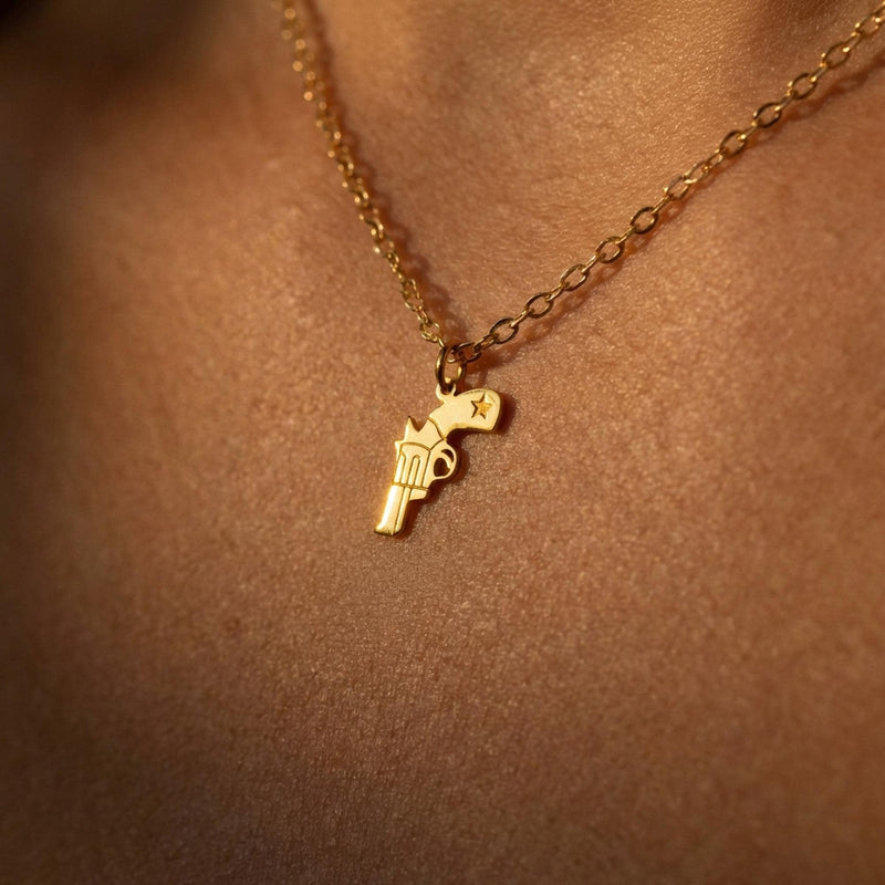 Fine gold necklace with a very small flat revolver pendant