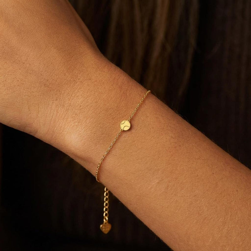 Fine gold chain bracelet with a very small round tennis ball charm (2 of 8)
