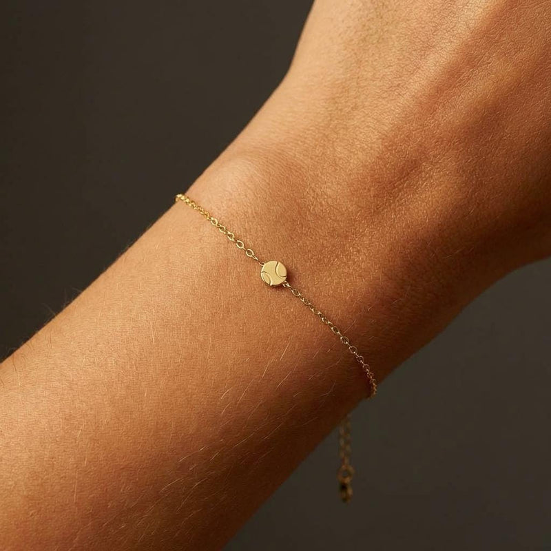 Fine gold chain bracelet with a very small round tennis ball charm (7 of 8)