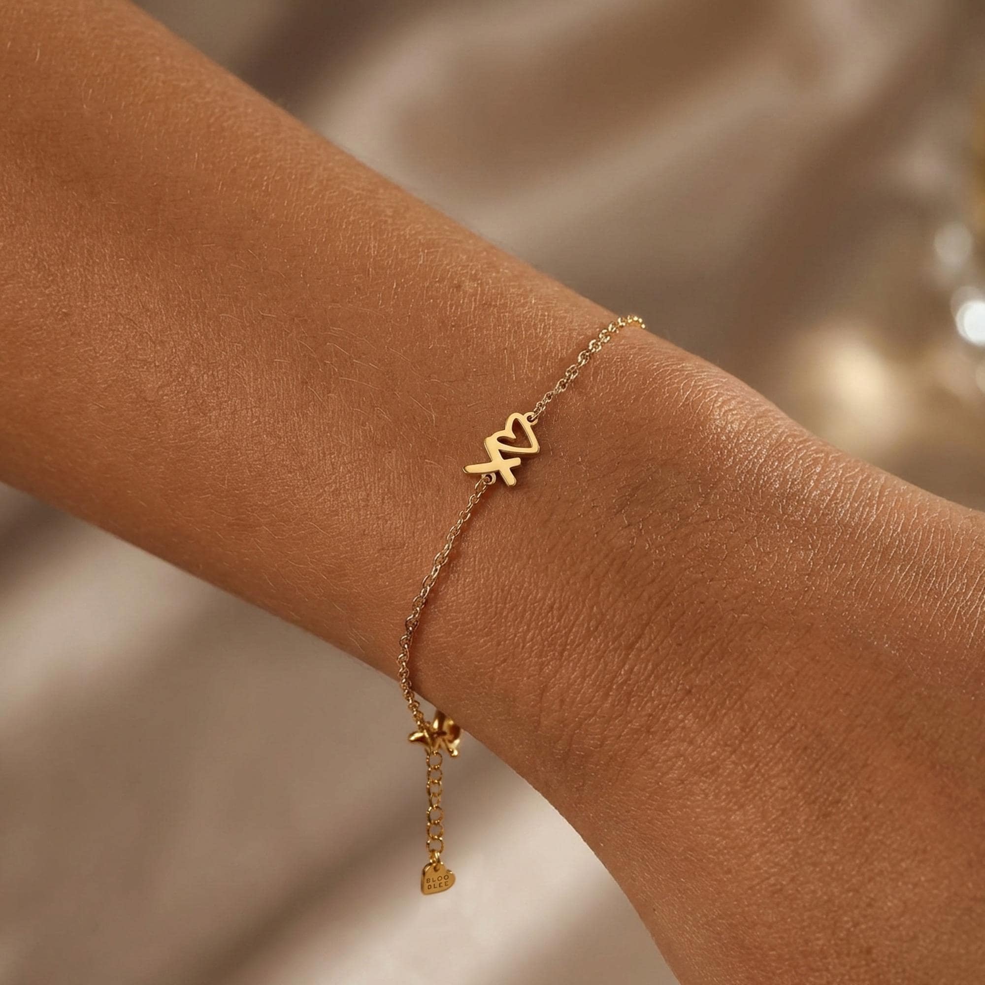 Fine gold chain bracelet with a small XOXO letter charm (2 of 6)