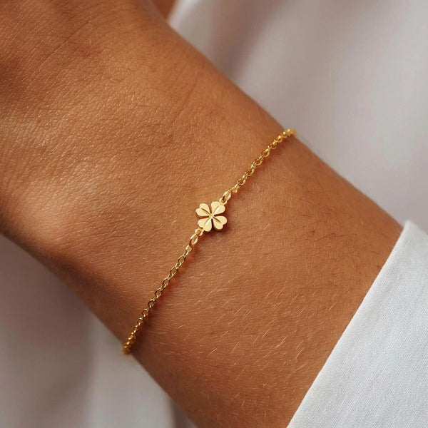 Fine gold chain bracelet with a very small four leaf clover charm