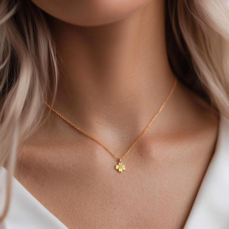 Fine gold chain necklace with a very small four leaf clover pendant (2 of 6)