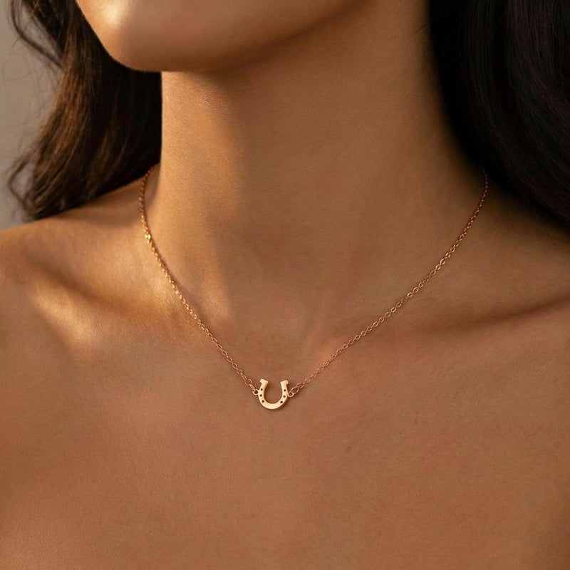 Tiny gold horseshoe pendant with nail holes on a fine chain (10 of 11)