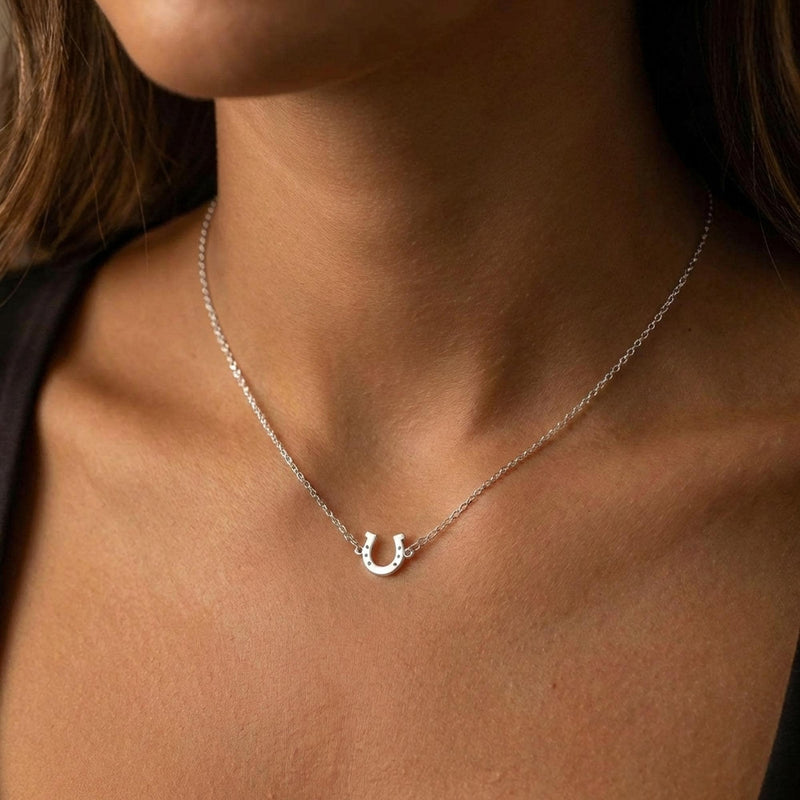Tiny gold horseshoe pendant with nail holes on a fine chain (11 of 11)