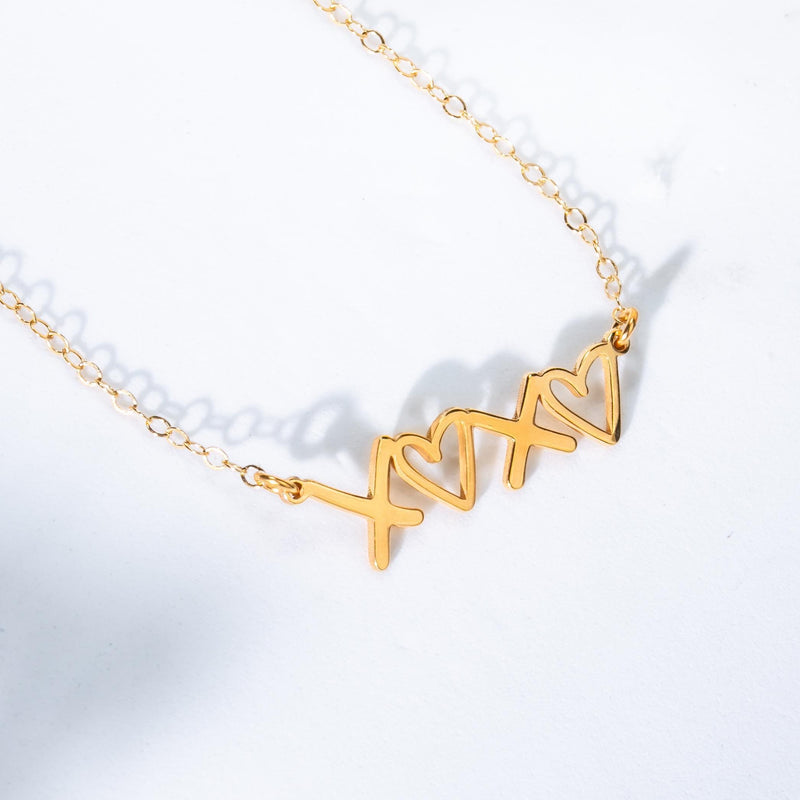 Small script XOXO pendant in gold on a fine cable chain