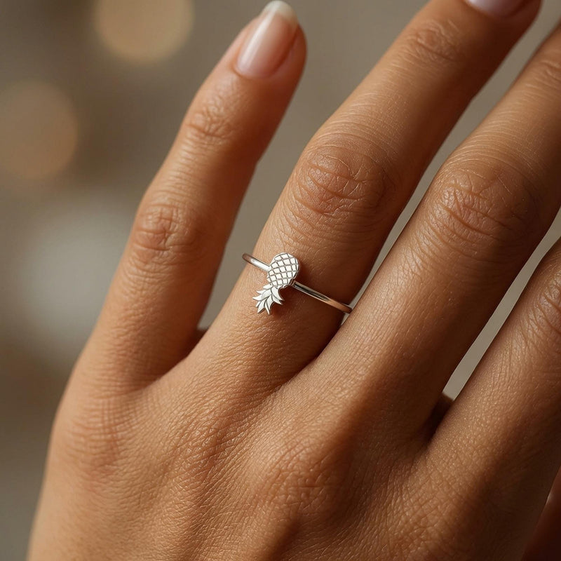 Thin gold ring with a small pineapple sitting on the crown of the band. (3 of 8)
